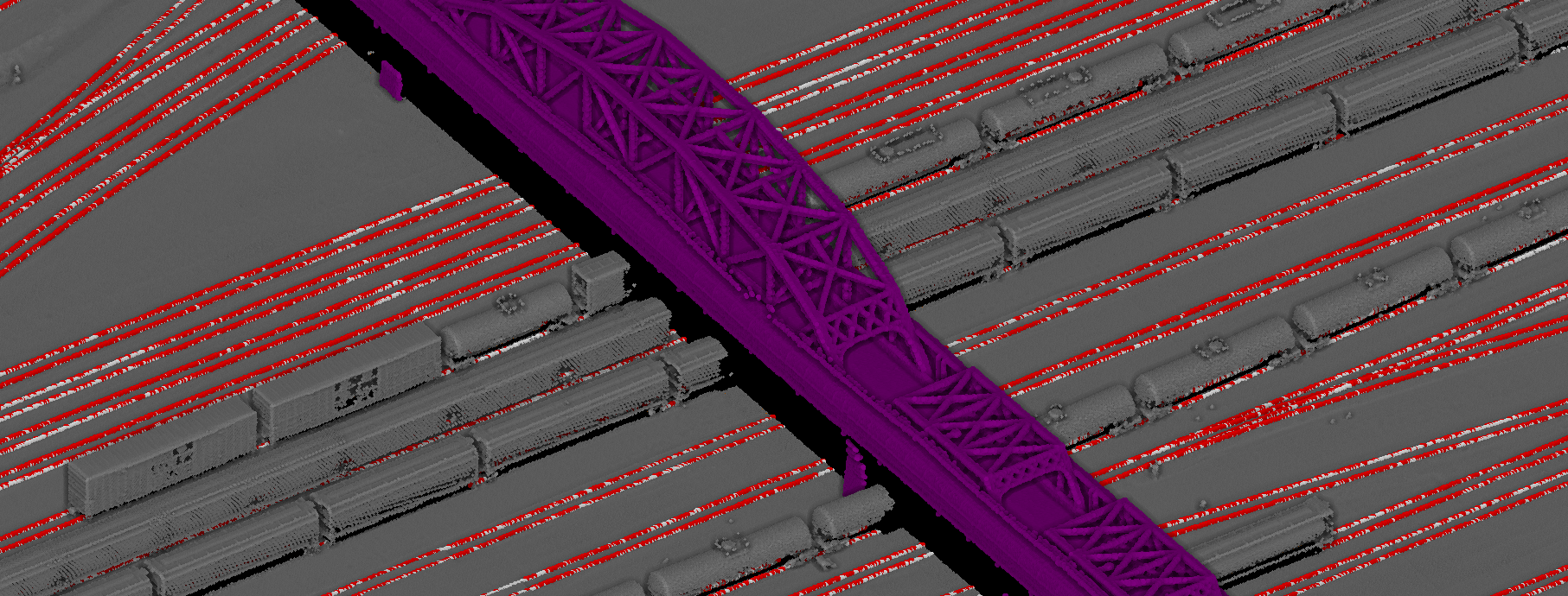 Classified aerial LiDAR of a steel railway bridge crossing multiple tracks with rails highlighted in red.