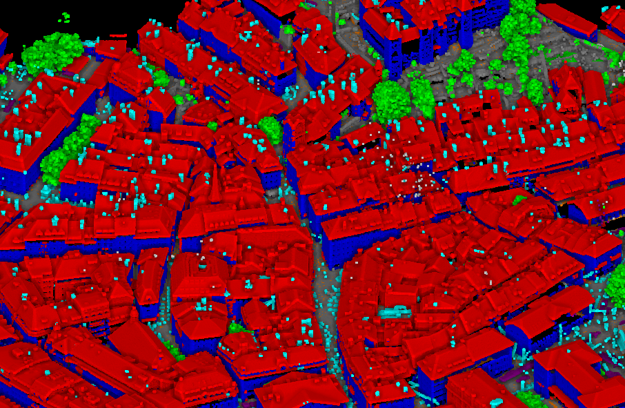Classified aerial LiDAR point cloud of a dense urban area with buildings, ground and vegetation colour-coded.
